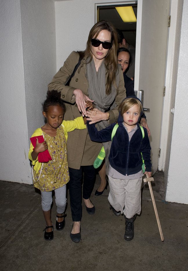 Angelina Jolie, brown trench coat, black ballet flats, black leggings, sunglasses, brown scarf, Shiloh, Zahara